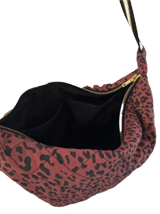 Leopard print bag with a black interior on a white background