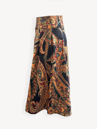 Long, patterned skirt with a mix of orange, black, and green on a white background