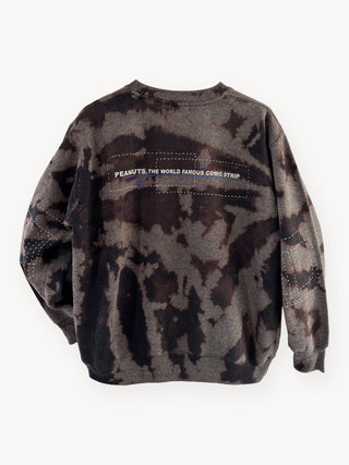 Camouflage-patterned sweatshirt with 'Peanuts, The World Famous Comic Strip' text on a white background