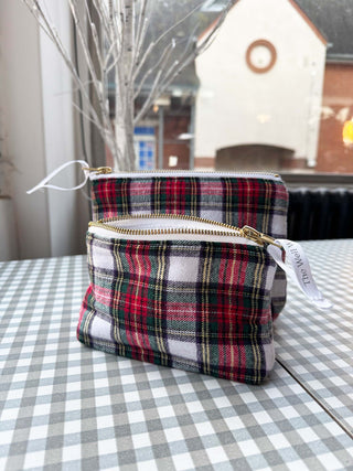 Plaid patterned pouch with gold zipper on a checkered tablecloth