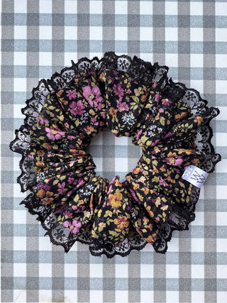 Floral scrunchie with black lace on a checkered background