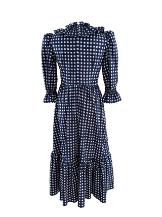 The Trixie Dress in navy & white hand block print, with a flowing skirt, ruffled hem, and side pockets for a perfect blend of comfort and style.
