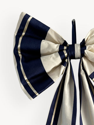Navy and white striped bow on a white background