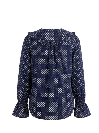 Navy blue blouse with white polka dots on a white background