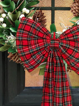 red tartan bow on wreath on door