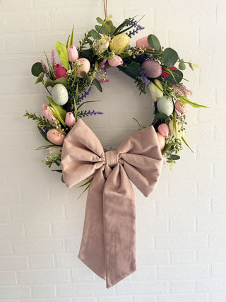 Eco-friendly fabric bows on a vibrant spring Easter wreath, adding a charming touch to seasonal decor with sustainable materials