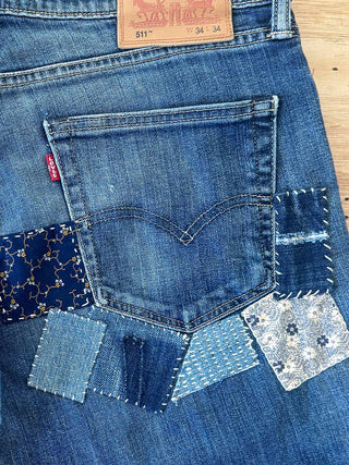 Close-up of a Levi's patchwork denim product on a wooden surface