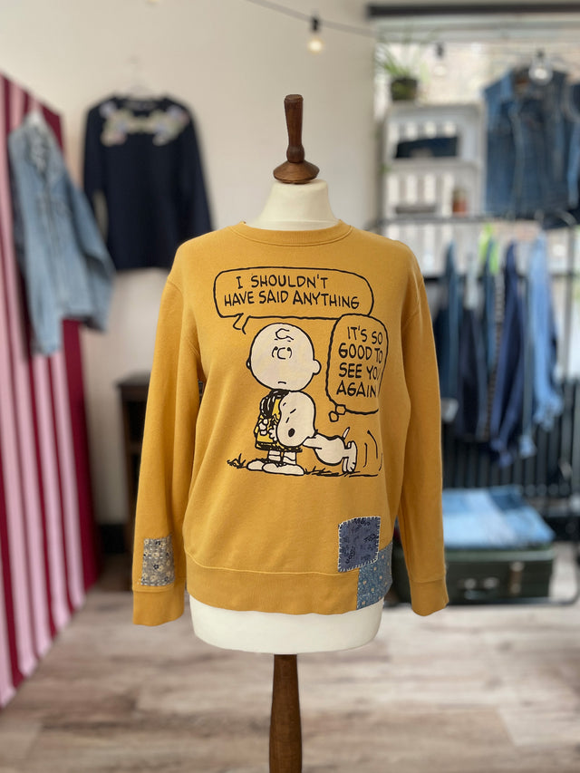 The Well Worn yellow snoopy sweatshirt on mannequin
