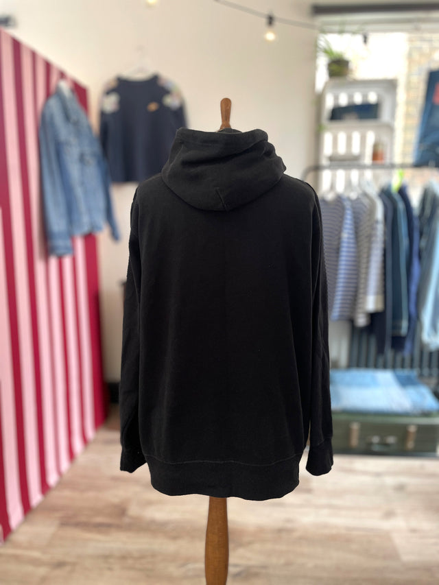 The Well Worn hooded sweatshirt on mannequin back