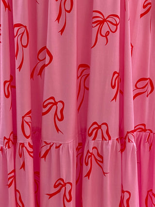 Mannequin showcasing a pink bow dress, highlighting its feminine shape and eco-friendly craftsmanship.