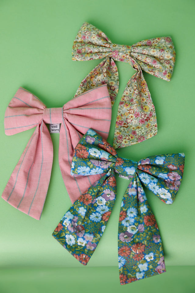 The Well Worn fabric bows on green background