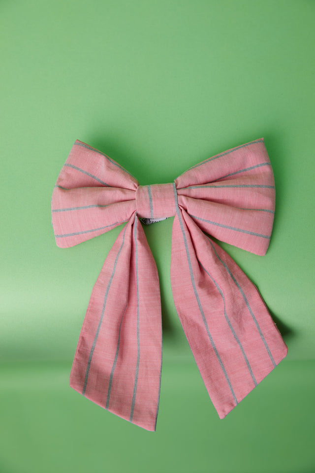 The Well Worn pink stripe fabric bow on green background