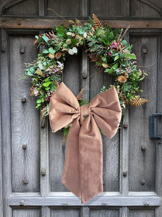velvet bow on wreath on door
