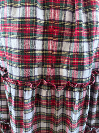 Close-up of a plaid fabric with red, green, and white colors.