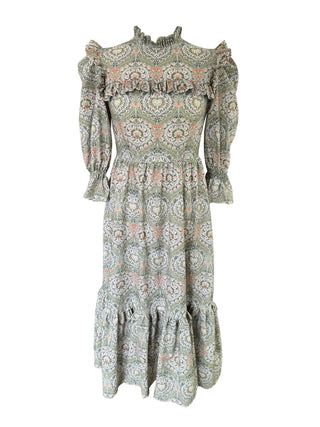 Green patterned dress with long sleeves on a white background