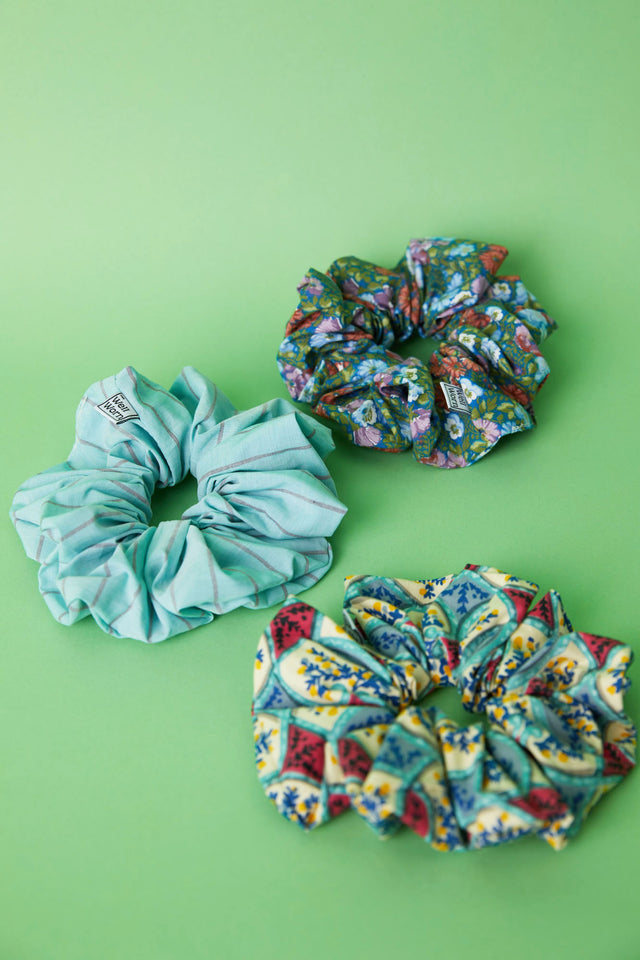 The Well Worn printed scrunchies on green background