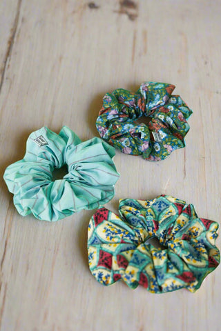 printed scrunchies on green background