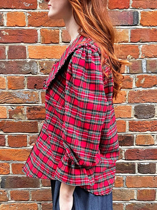 women wearing red tartan blouse detail