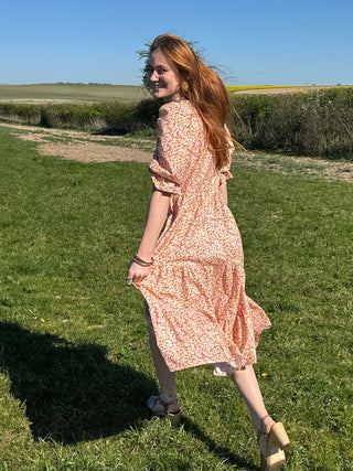 women in field wearing sustainable deadstock cotton midi dress
