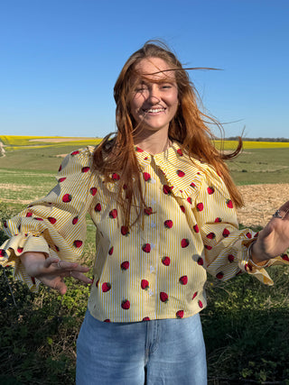 model wearing strawberry print blouse
