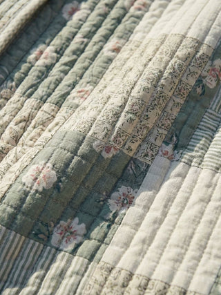 Close-up of a quilt with floral patterns and stripes