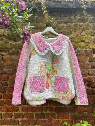 quilted jacket hanging on outside wall in garden