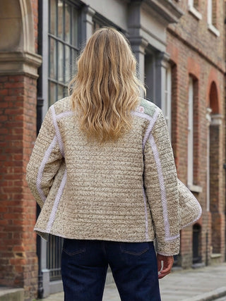 back woman wearing quilted jacket