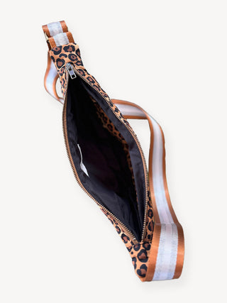 Leopard print sling bag with a black interior on a white background