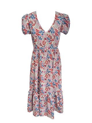 A short-sleeve V-neck midi dress with puff sleeves and a ruffled hem, featuring a dense red, blue, and yellow floral print on a light beige background.