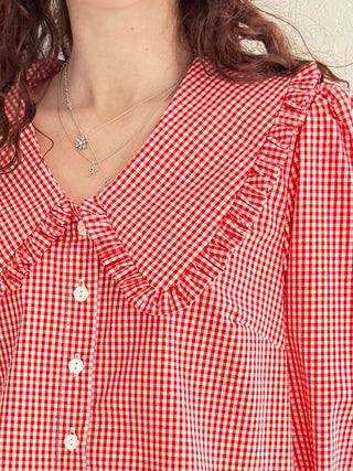 Sustainable red gingham blouse with oversized collar and corozo buttons on model