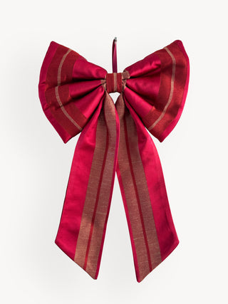 Red decorative bow with gold stripes on a white background