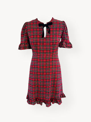 Red plaid dress with a black bow on a white background