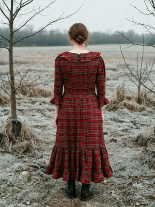 women in red tartan dress in winter landscape