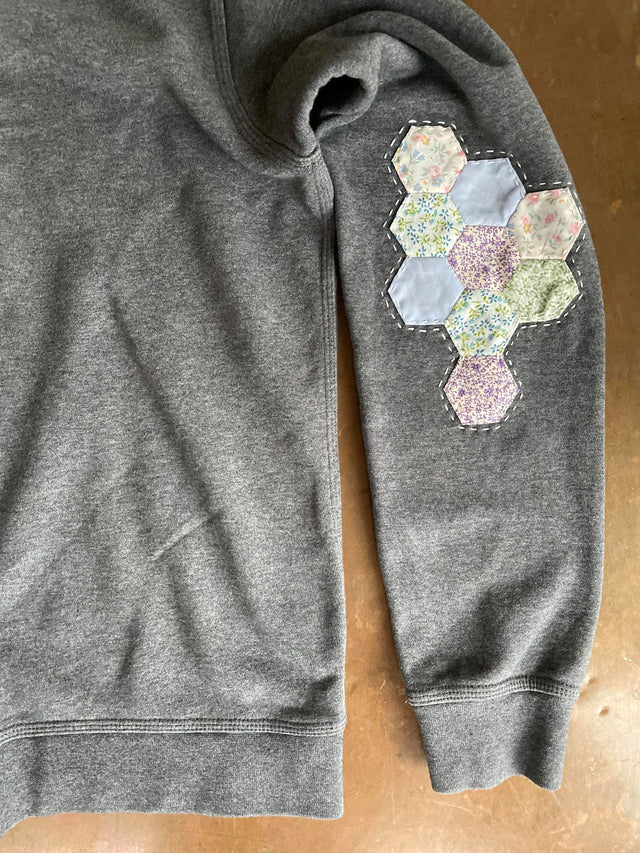 The Well Worn upcycled sweatshirt on table patchwork