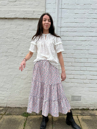 Model wearing The Well Worn Romana Skirt – a tiered floral midi skirt made from deadstock cotton.