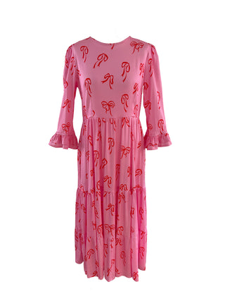 Pink bow dress displayed on mannequin, showcasing a flattering silhouette and delicate bow print
