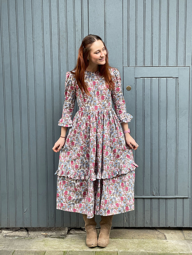 The Well Worn woman wearing floral dress