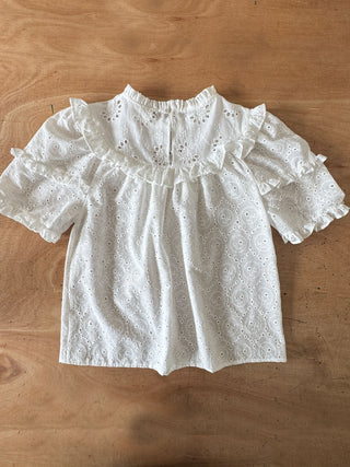 White lace blouse on a wooden surface