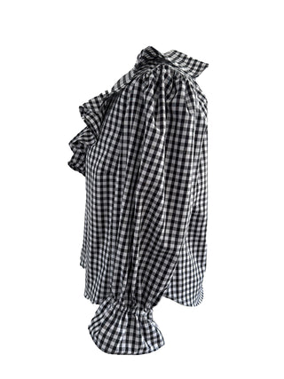 Black and white checkered dress with ruffled details on a white background