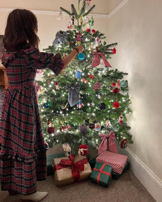 woman wearing tartan dress by tree