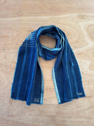 Blue striped scarf on a wooden surface