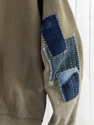 Brown jacket with denim patchwork on a white background