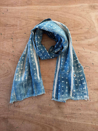 Blue patterned scarf on a wooden surface