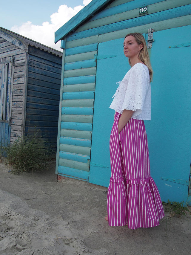 The Well Worn white tie front blouse on model by beach hut