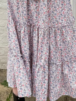 Close-up of ruffle trim and floral cotton fabric on ethically made UK skirt.