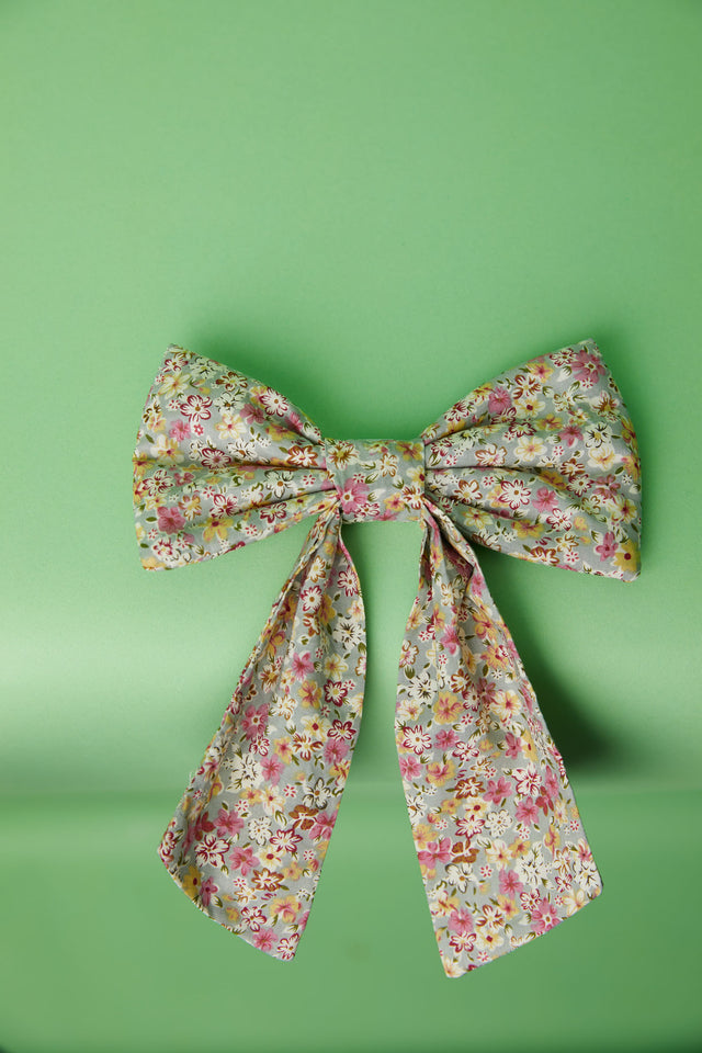 The Well Worn floral print fabric bow on green background