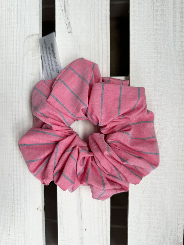 The Well Worn soft pink stripe scrunchie on wooden table
