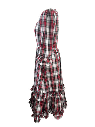 A red, black, and white plaid maxi dress with a ruffled hem and a matching fabric tie belt at the waist, shown from a side profile on a white background.