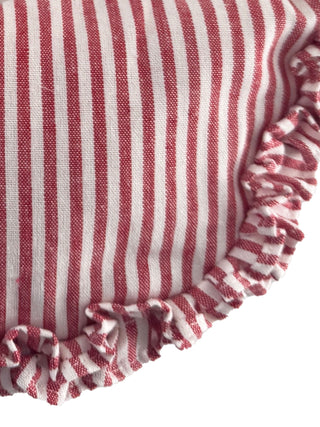 Close-up of a red and white striped fabric with ruffled edge on a white background