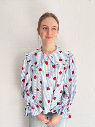 women in strawberry blouse